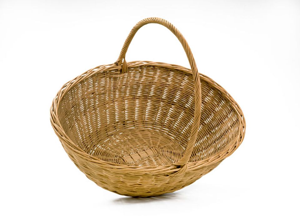 A basket that has a small circular base with it's body flaring our to a larger circle with a long handle.