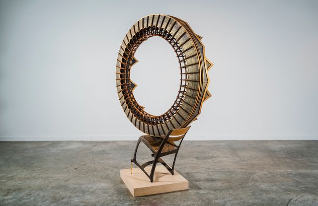 This is a picture of a circular sculpture piece resting on a chair.