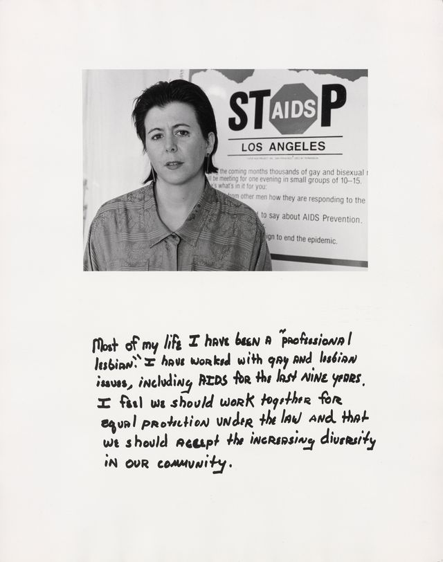 A black and white photograph of a person with short hair standing in front of a sign that says "Stop AIDS Los Angeles."