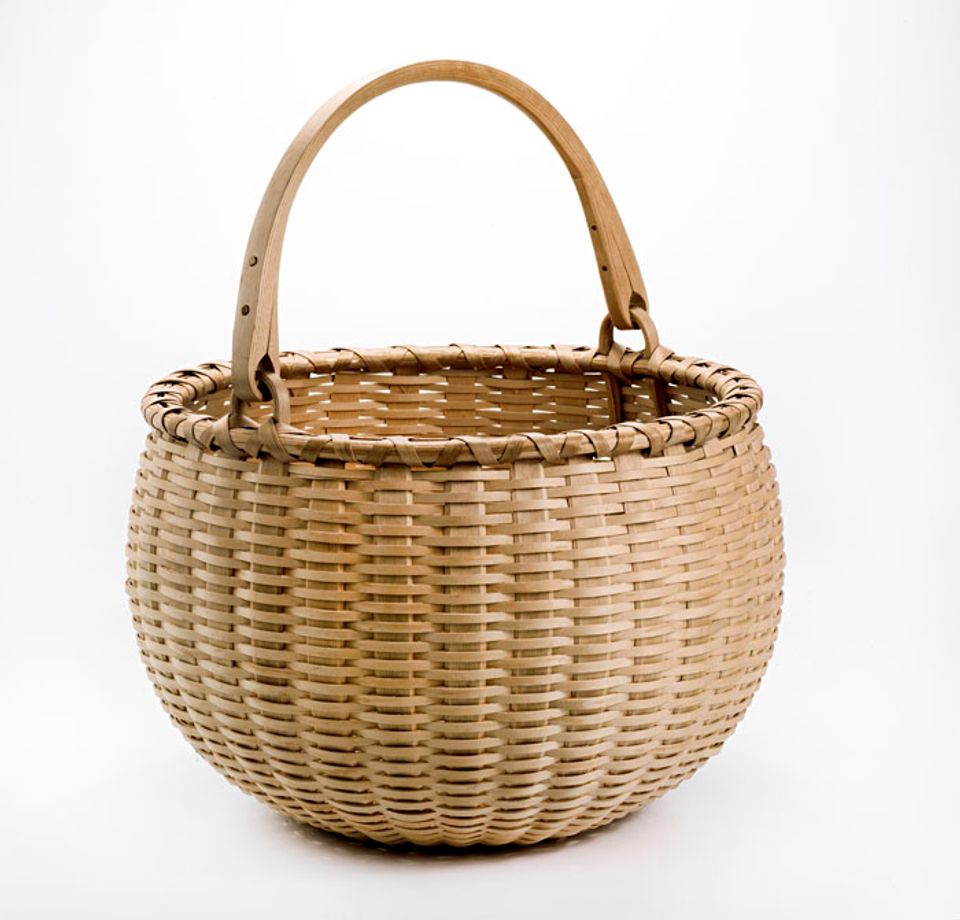 A basket that's perfectly circular with a handle. 