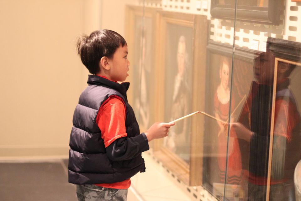 A boy doing a scavenger hunt at the Luce Foundation Center.