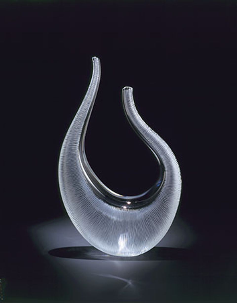 A translucent glass vessel shaped like an organic 'U'