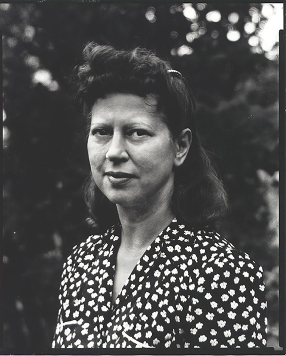A photograph of a woman in a black and white shirt.