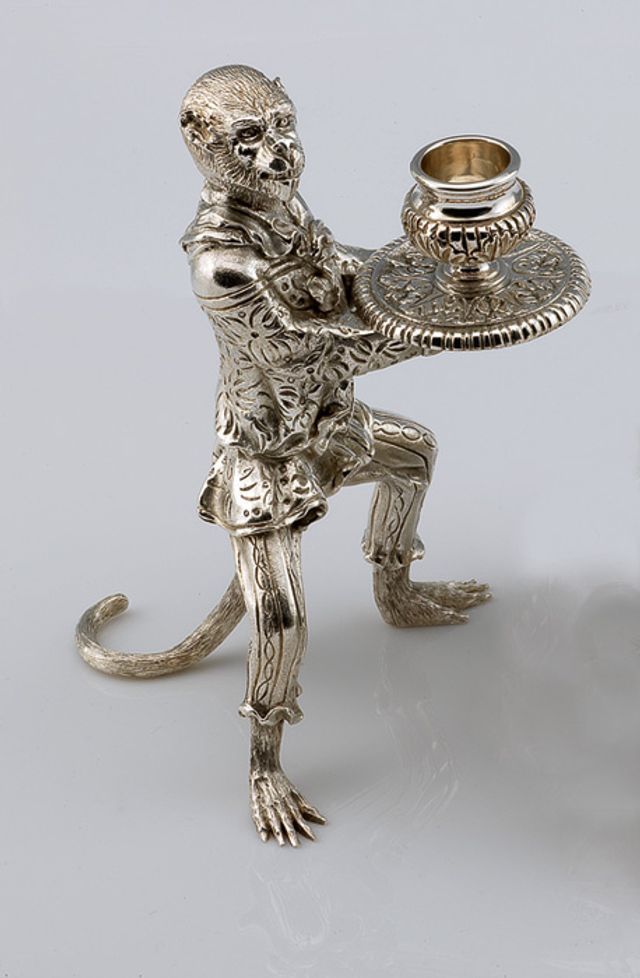 An image of Vitali's silver candlestick holder in the shape of a monkey.