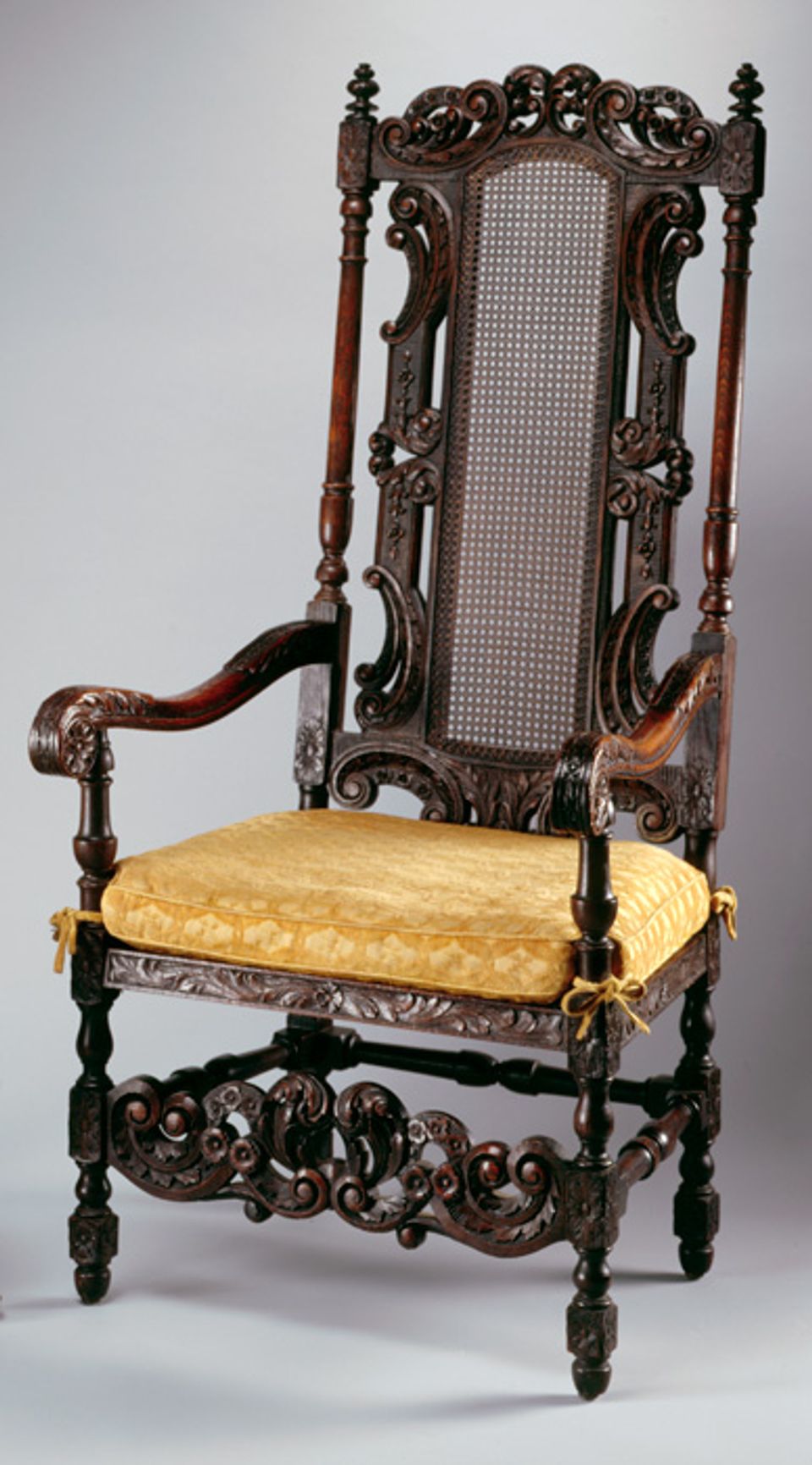 An image of Davenport's white oak and cane armchair with yellow seat cushion.