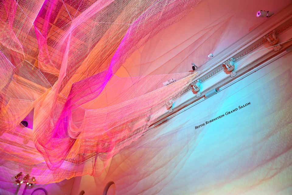 A photograph of colorful mesh hung from the ceiling inside the Grand Salon at the Renwick Gallery.
