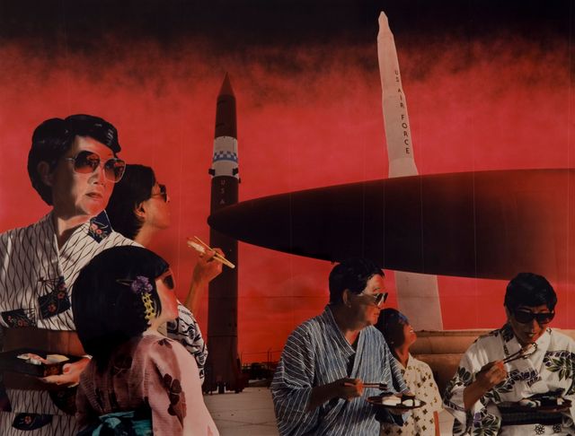 Group of Japanese people wearing kimonos and eating sushi in the foreground with us air force missiles in the background 