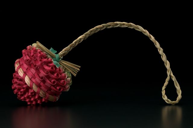 A sculpture using basketry shaped like a strawberry.