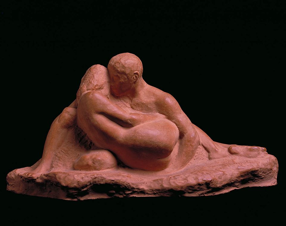 Lot - Onyx sculpture of a young couple embracing.
